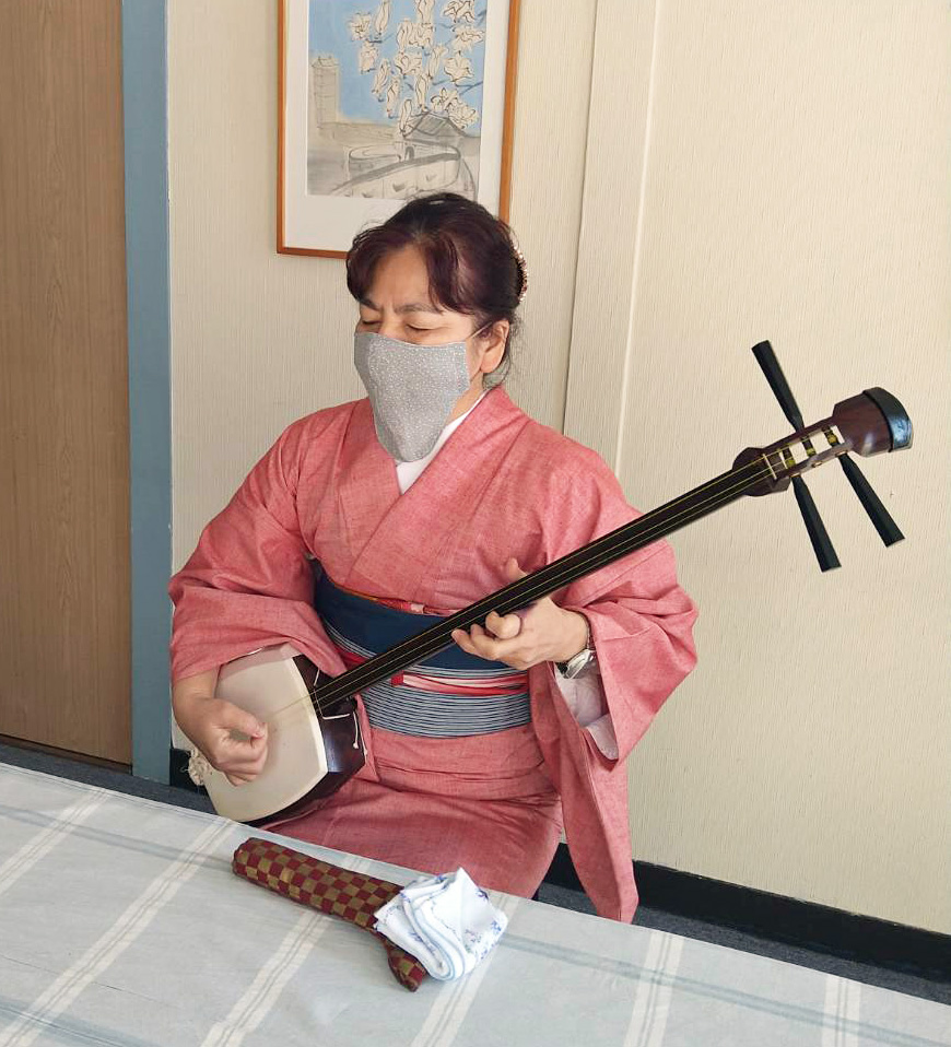 三味線を弾きながら瞽女唄（ごぜうた）を披露する広沢里枝子の写真